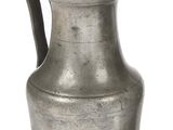 an old silver pitcher with a handle on a white background