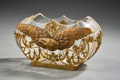 a glass bowl with a gold decoration on it