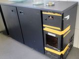 an image of a black and yellow refrigerator in a kitchen