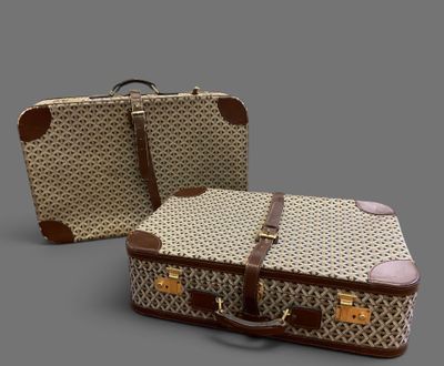 two pieces of luggage sitting next to each other on a gray surface
