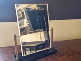 a mirror sitting on top of a wooden table