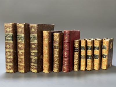 several old books are lined up in a row on a table