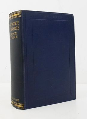 an old book sitting on top of a white table next to a white wall