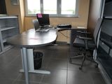 a desk with a laptop on it and a chair in front of it