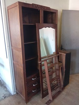 a wooden cabinet with a mirror on top of it
