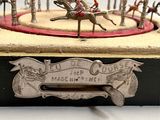 a small wooden box with a toy carousel on top of it