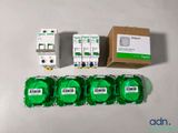 four green rolls of tape sitting on top of a table next to a box of green tape