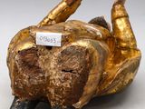 an image of a gold statue of a dog with a tag on it ' s neck