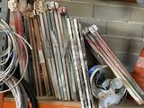 many pipes and hoses on a shelf in a garage