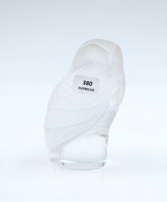 a white bird that is sitting on top of a glass