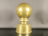 a close up of a golden ball on top of a black table