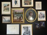 many framed pictures on the wall of this room