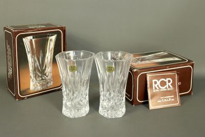 two clear glass vases and a box on a gray surface