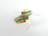 a close up of a gold ring with emeralds and diamonds