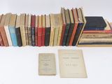 several old books are stacked on top of each other on a table