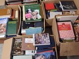 many books that are in boxes on the floor