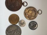 some coins are sitting on top of a table next to each other