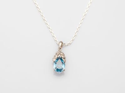 a blue topaz quartz and diamond pendant on a silver chain