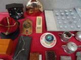 a red table with a lot of silver items on it