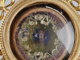 a picture of a gold and blue clock in the middle of a picture