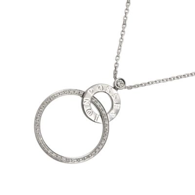 a close up of a necklace with two rings on a chain