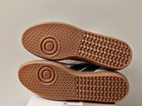 the soles of a pair of shoes are on top of a box
