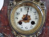 a close up of a clock that is on a table