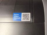 a close up of a printer with a qr code on it