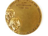 an image of a gold medal with two people on it