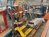 a fork lifter and a cart in a warehouse