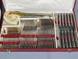 a red case with silverware in it on a table