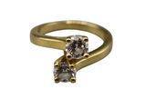 a close up of a gold ring with a diamond on it