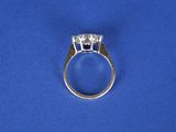 a close up of a diamond ring on a blue surface