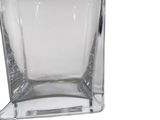 a glass vase that is sitting on a white surface
