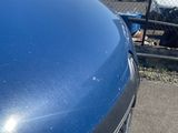 a picture of a blue truck parked in a parking lot