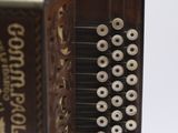 a close up of an old accordion with buttons on it