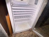 an open refrigerator that is sitting in the corner of a room