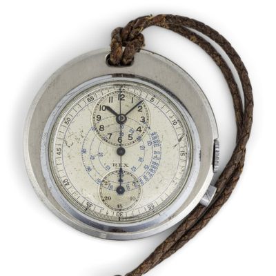 a silver pocket watch with a rope around it