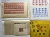 four envelopes with stamps on them sitting on top of a table