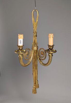 a gold chandelier with three candles hanging from it