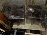 two washing machines sitting next to each other in a room
