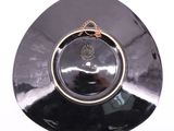 a black plate with a gold decoration on it