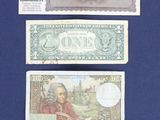three different types of paper money are displayed on a blue surface