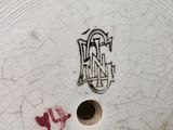 a close up of a white plate with a design on it