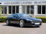 the black sports car is parked in front of the building