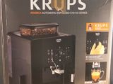 a box of krups coffee maker on a table