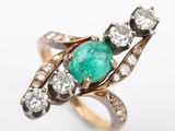 an image of an emerald and diamond ring on a white background