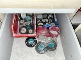 two bins filled with assorted items in a drawer