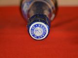 a close up of a bottle of beer on a red cloth