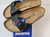 a pair of sandals that are sitting on top of a box